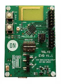 녹색 회로 기판에는 RSL15 EVD V1.1 설명을 표시하며, 스위치, LED 및 커넥터를 포함한 다수의 전자 부품이 있습니다.