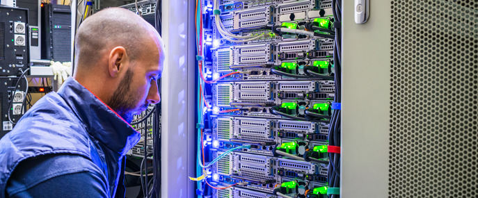 A Specialist Connects The Wires In A Server Room