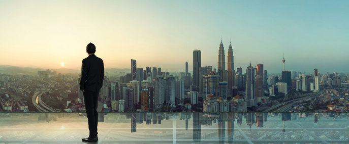Asian_Businessman_Looking_Over_City_Skyline
