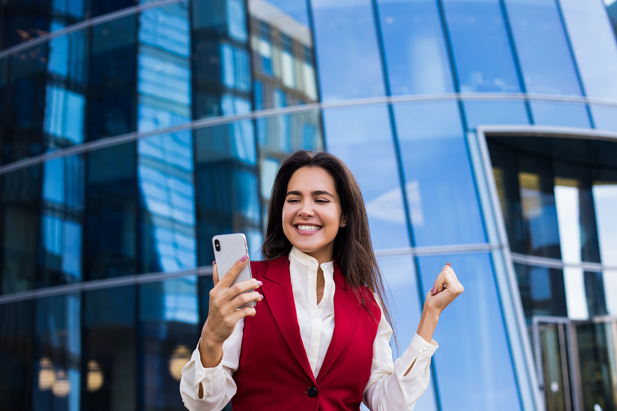 Smiling Woman Entrepreneur Reading Good News On Mobile Phone Shutterstock 1248952660 Smiling Woman Entrepreneur Reading Good News On Mobile Phone