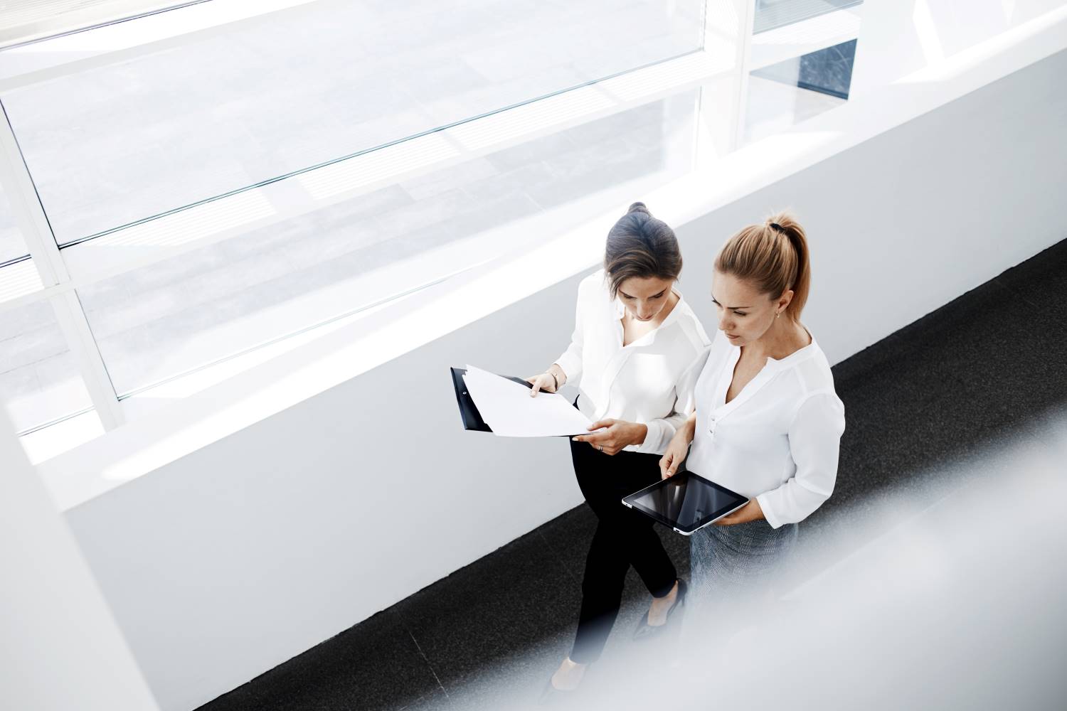 Two_Businesswomen_Walking_With_Tablet